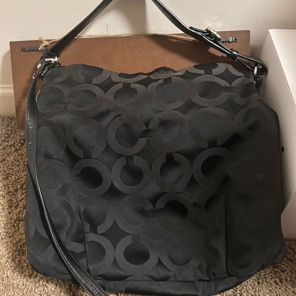 Coach purse black with red lining. Preowned good condition.